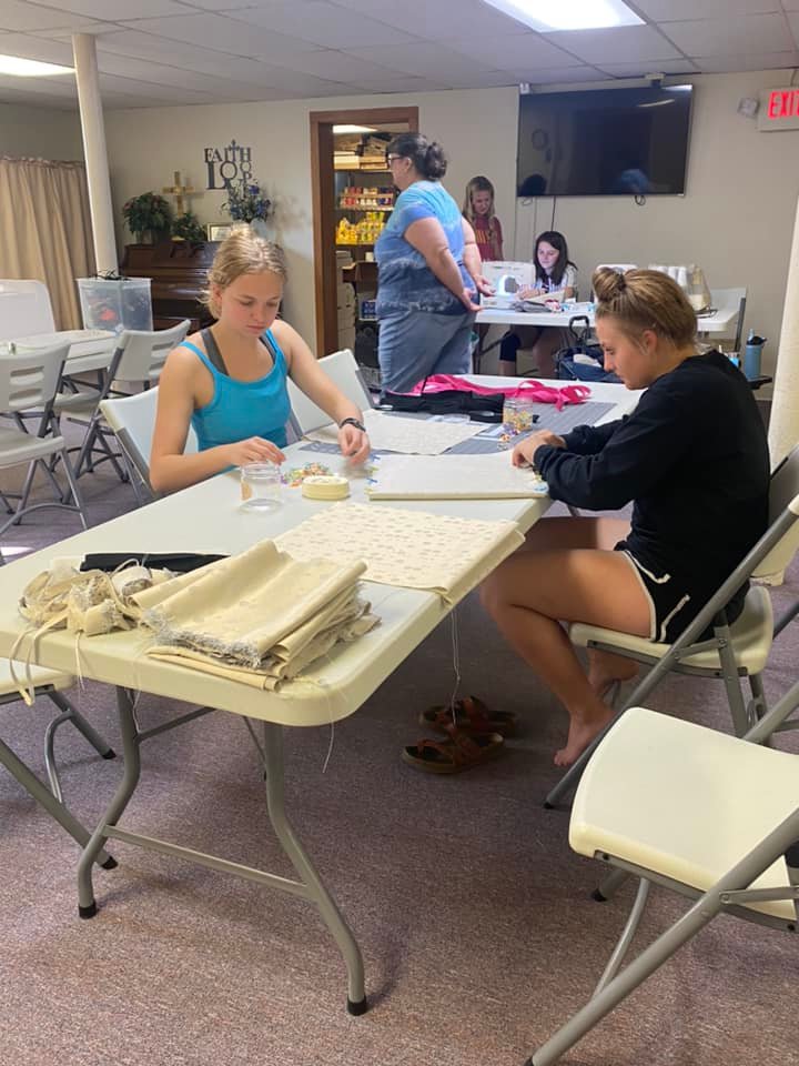 Highlander 4-H members  Brena Hazelett, Kerra Longbine, Shauna Sublette, and Gwen Piette were  assisted by Brenda Bean from Ainsworth Community Church in sewing supply bags for a church mission.  